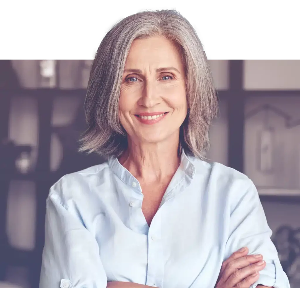 smiling older woman with her arms crossed looking confident