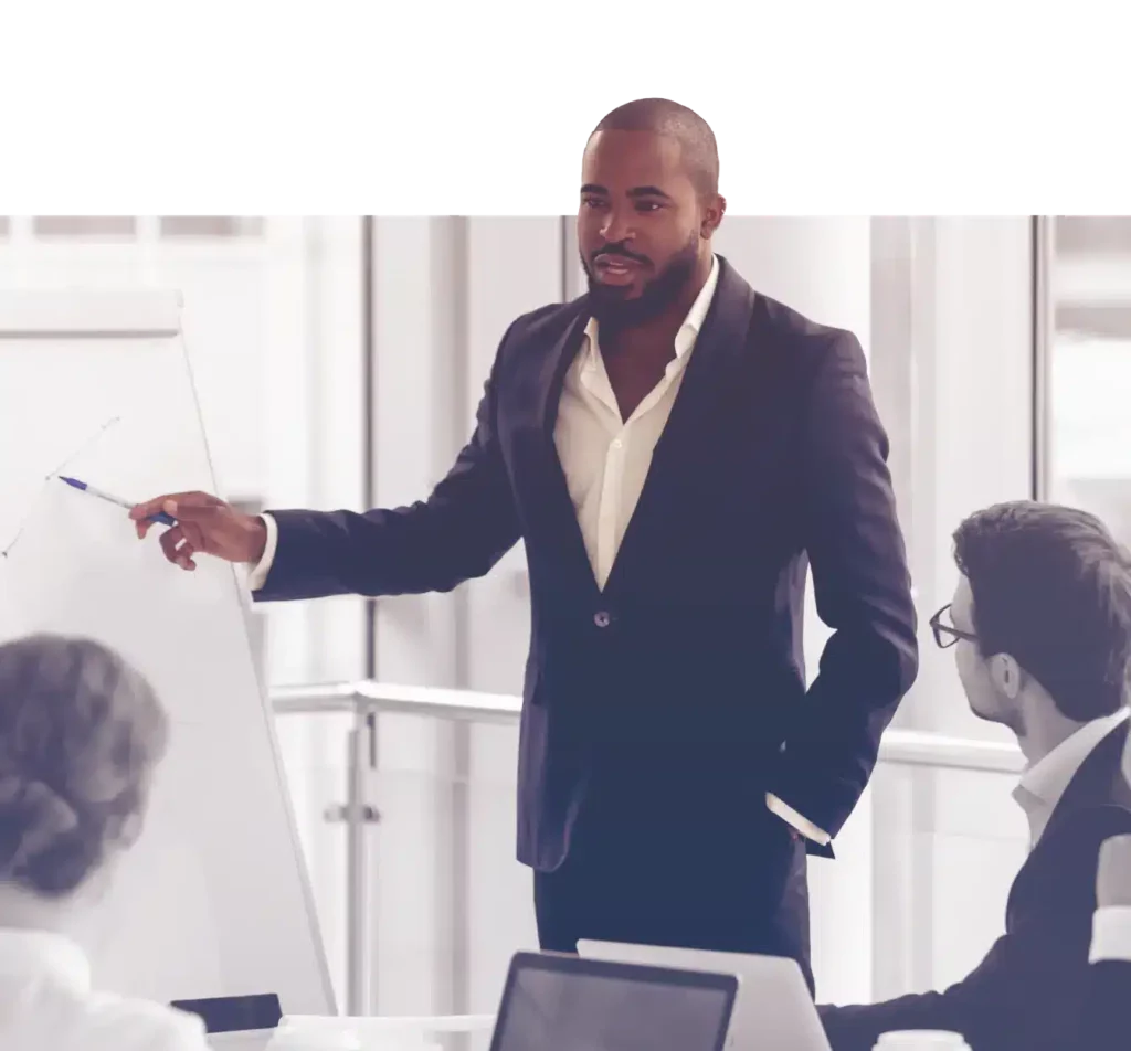 man standing in front of flip chart in a meeting