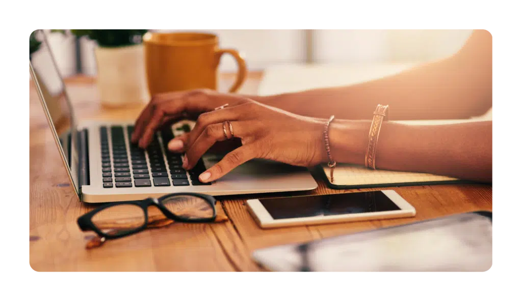 Hands typing on a laptop keyboard