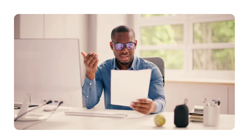 Boss reviewing employees work and looking pained