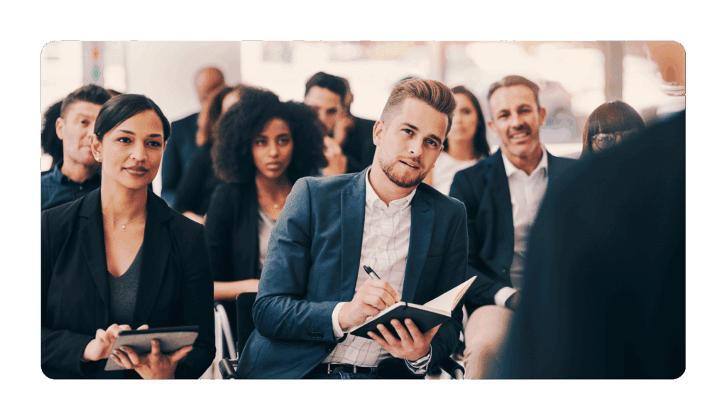 Business professional sitting in a lecture hall learning new skills