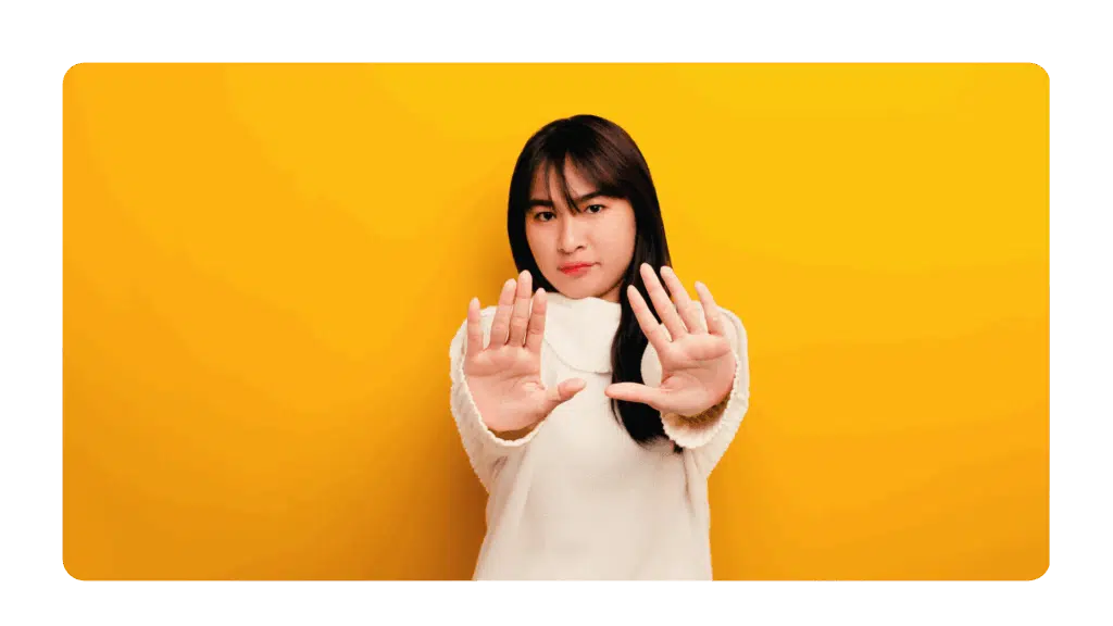 woman holding up her hands with a stop motion