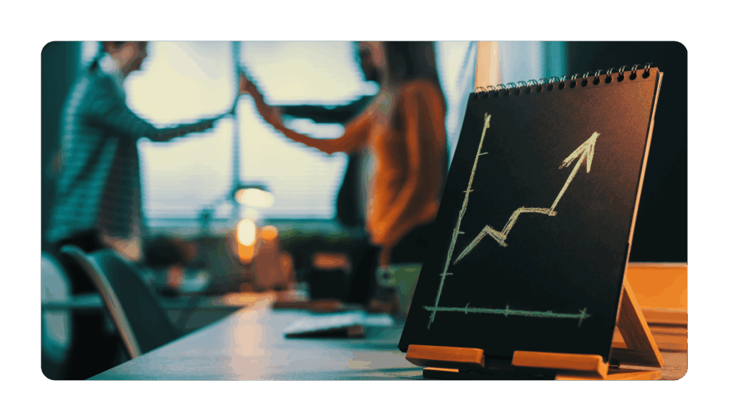 team giving each other a high five in the background with a chart that has an arrow going up in the foreground