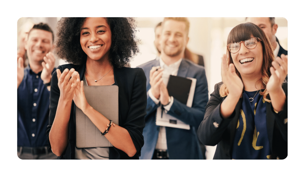 Smiling employees happy to work at a company that prioritizes employee wellbeing